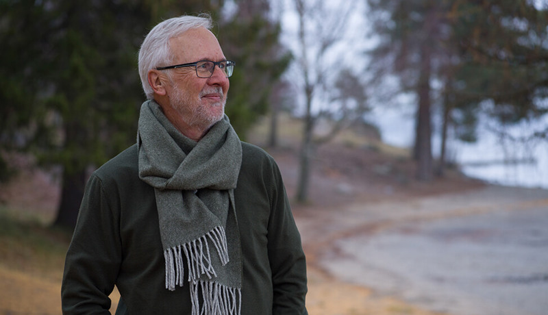 En eldre mann står ute og ser tankefull ut